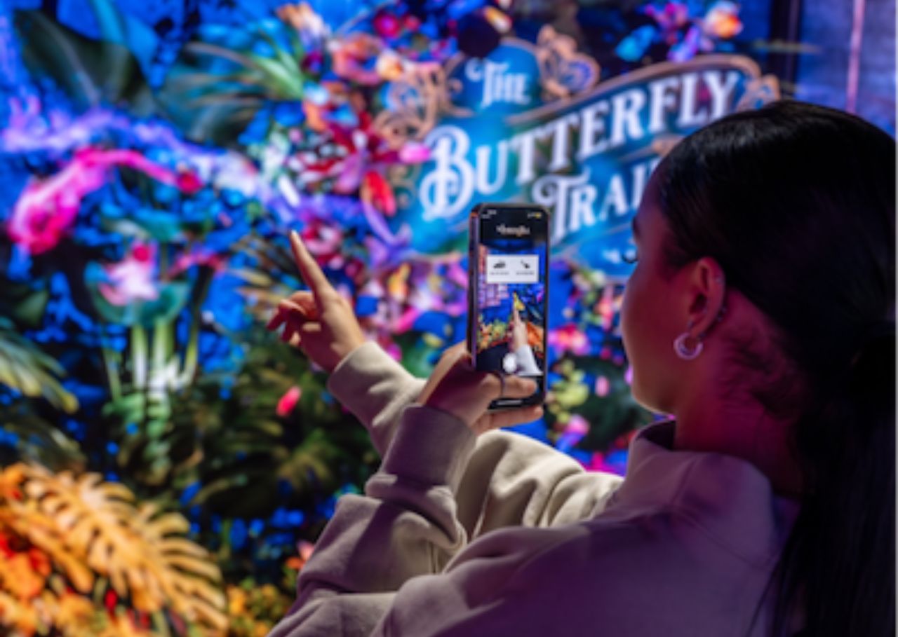 Girl interacting with The Butterfly Trail at Outernet